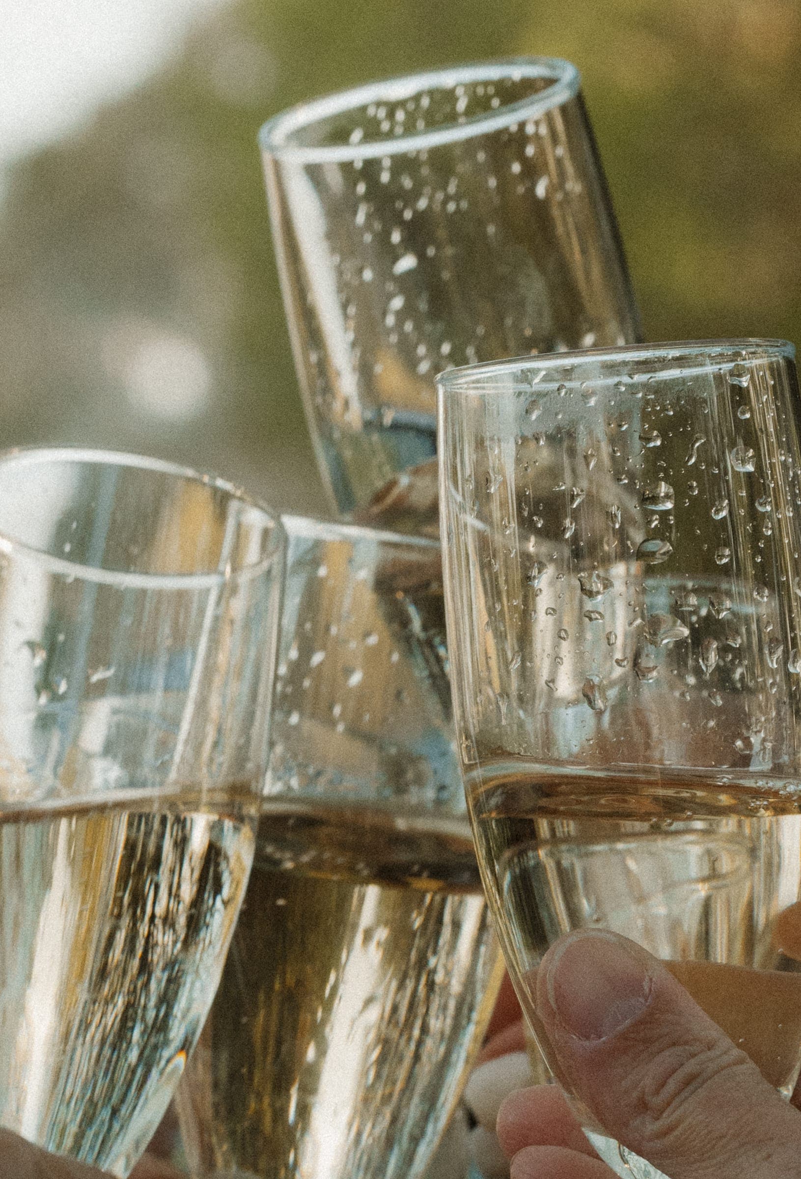 Champagne glasses meeting in a toast