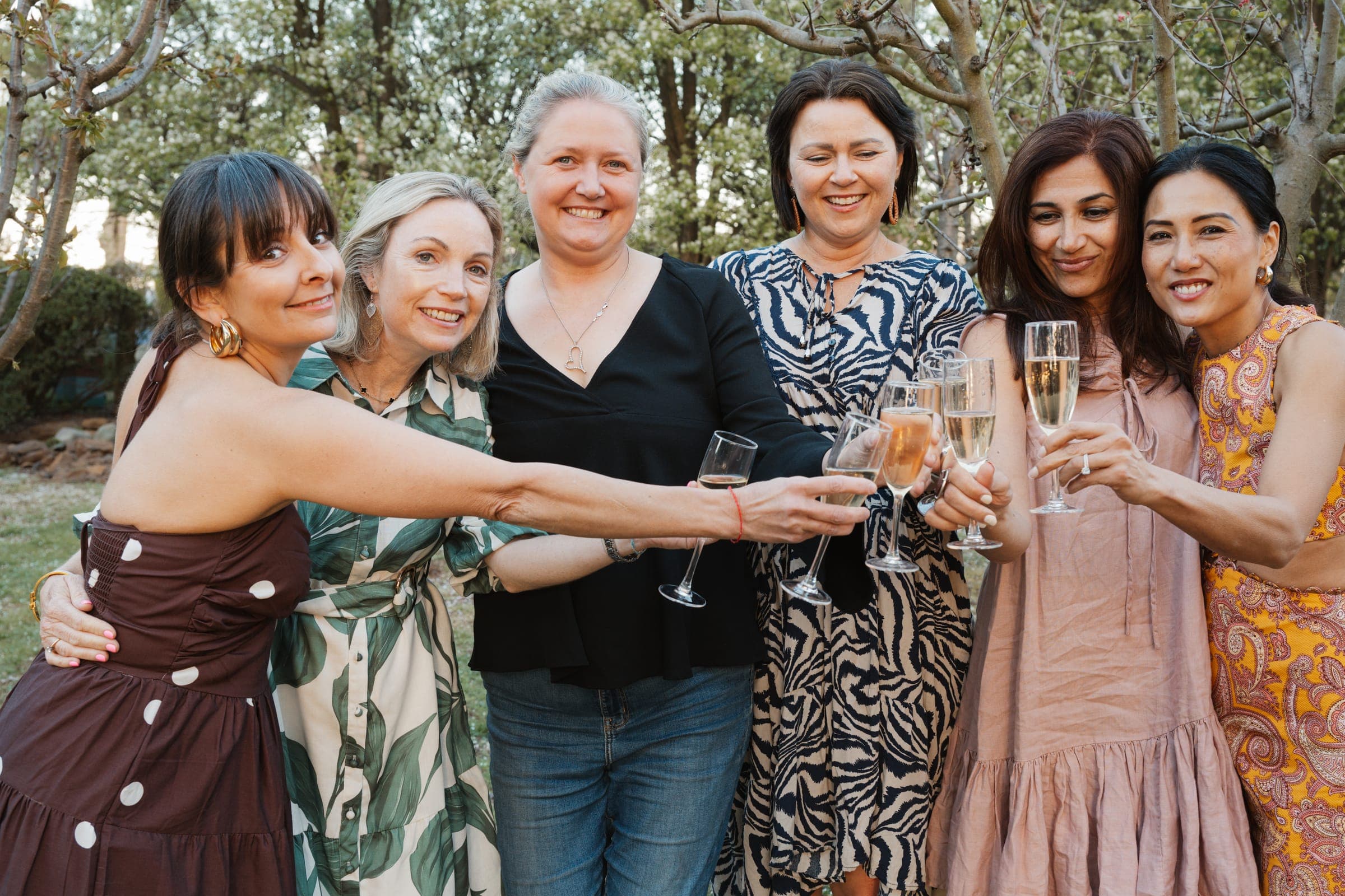 Friends raising a toast in the garden