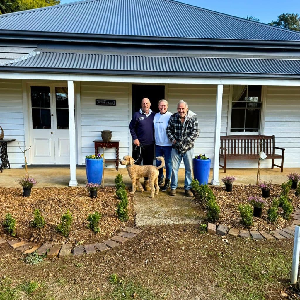 Family gathered in front of the farmhouse at Roseville